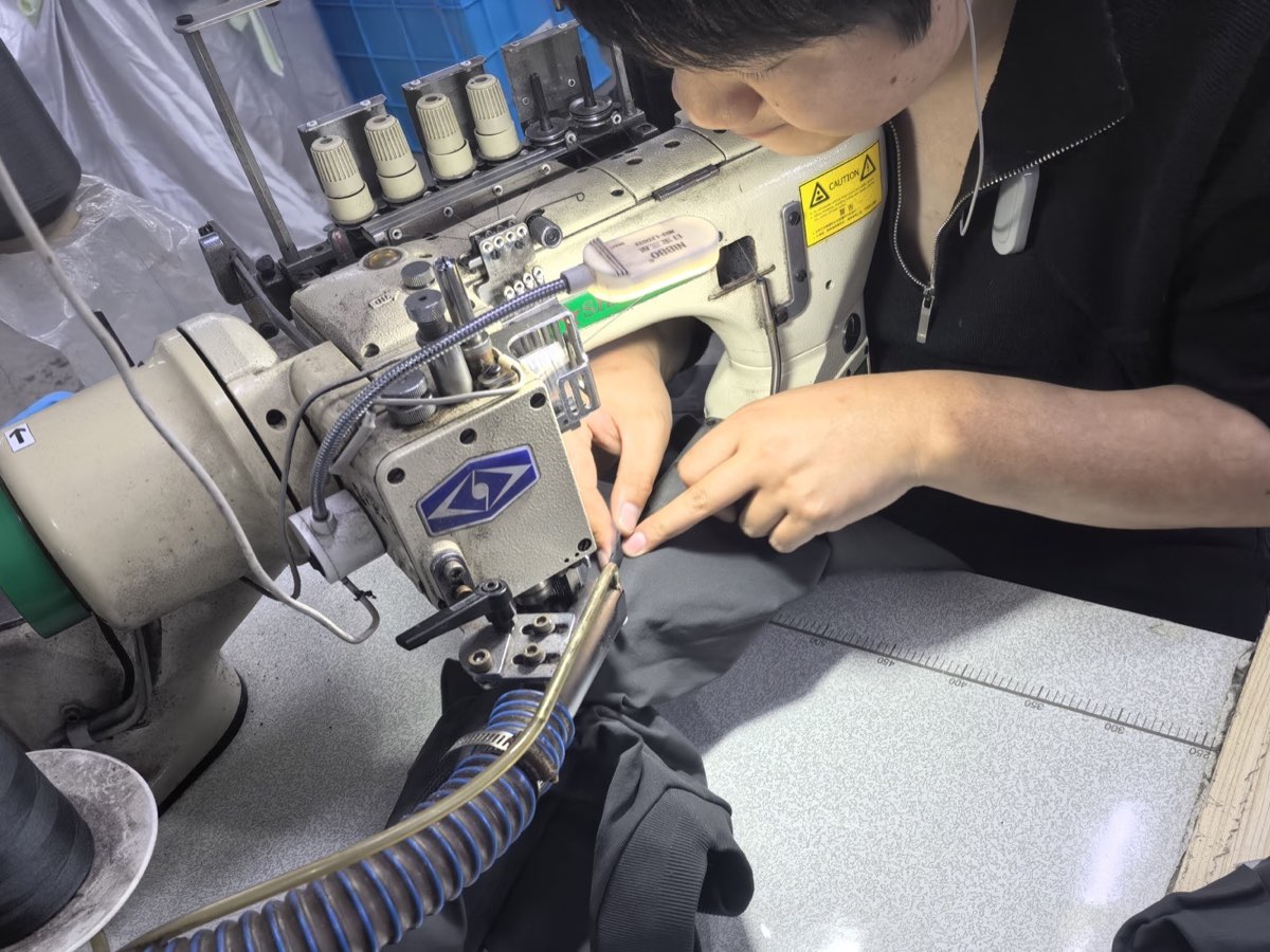 Operator sewing activewear on an industrial machine