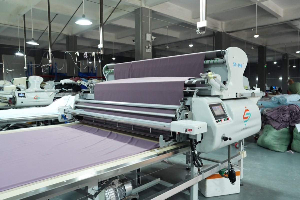Automated fabric spreading equipment in the Cut and Sew factory