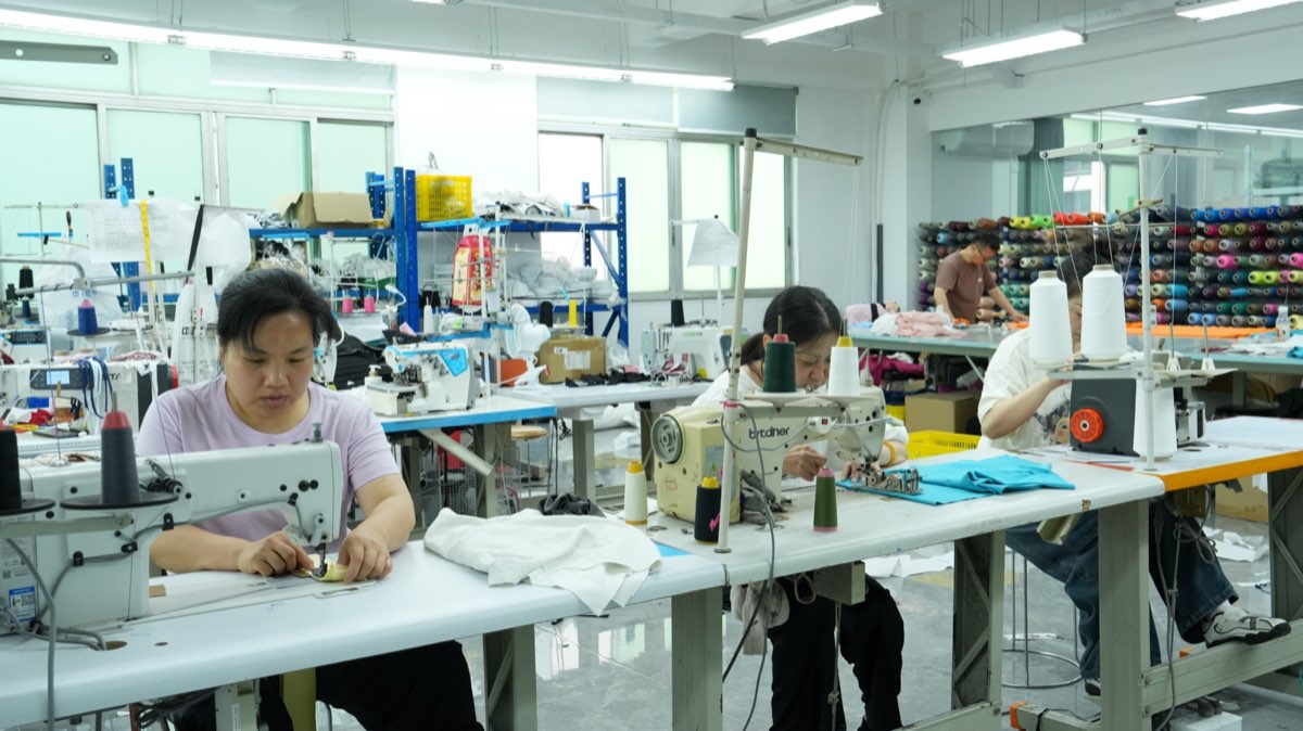 Cut and sew sample room with operators and industrial sewing machines